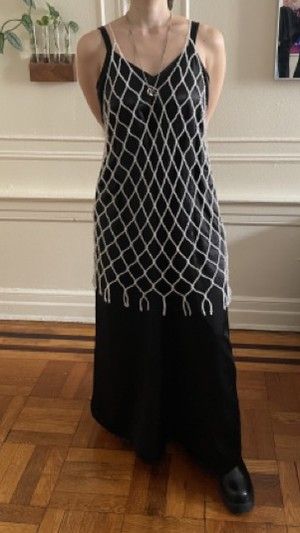 Chanel in a net overlay dress