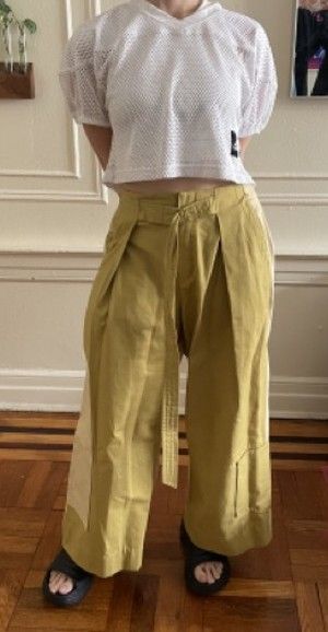 Chanel in mesh and wide-leg chartreuse trousers